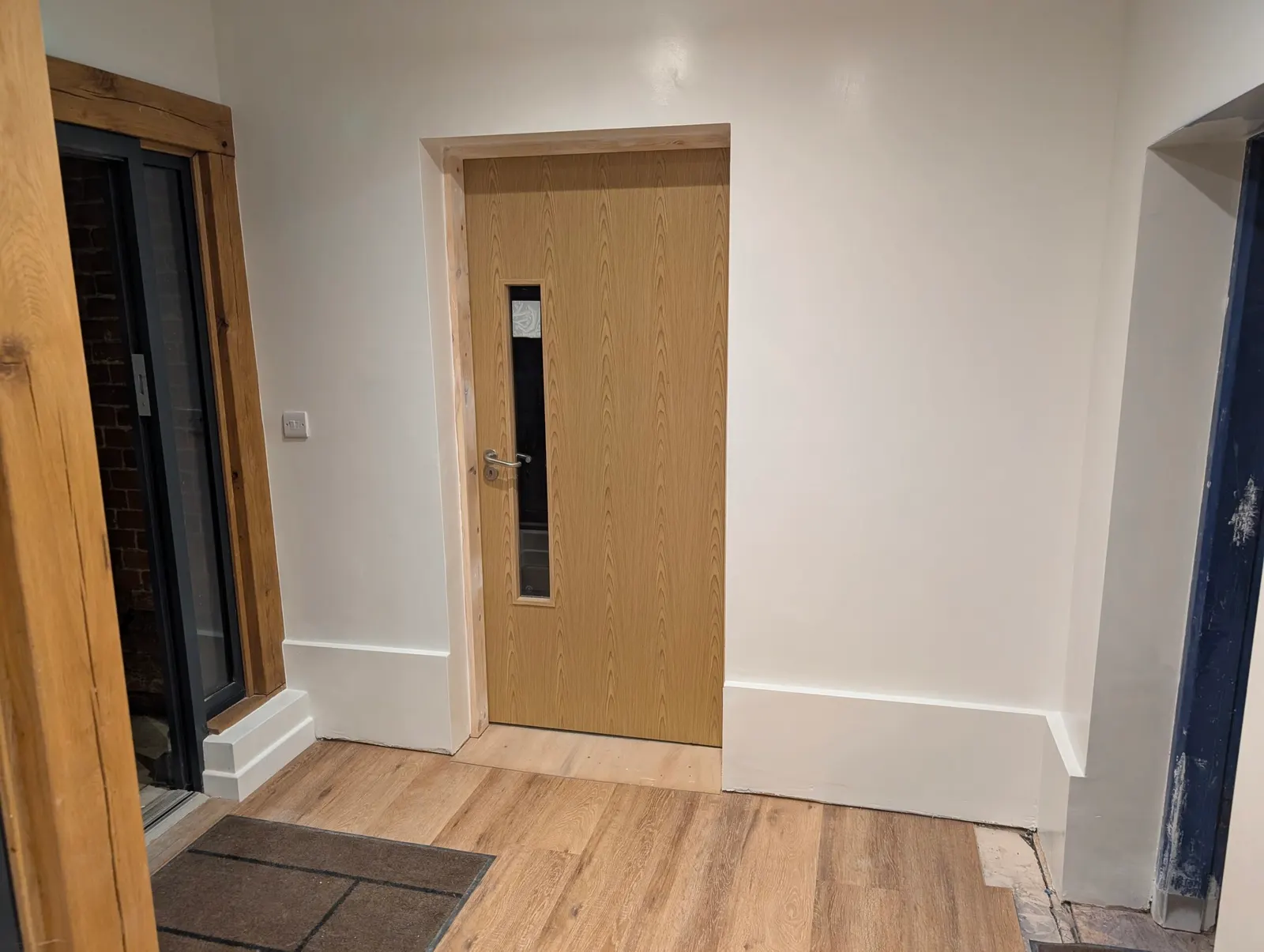 The finished corridor with its new door and flooring
