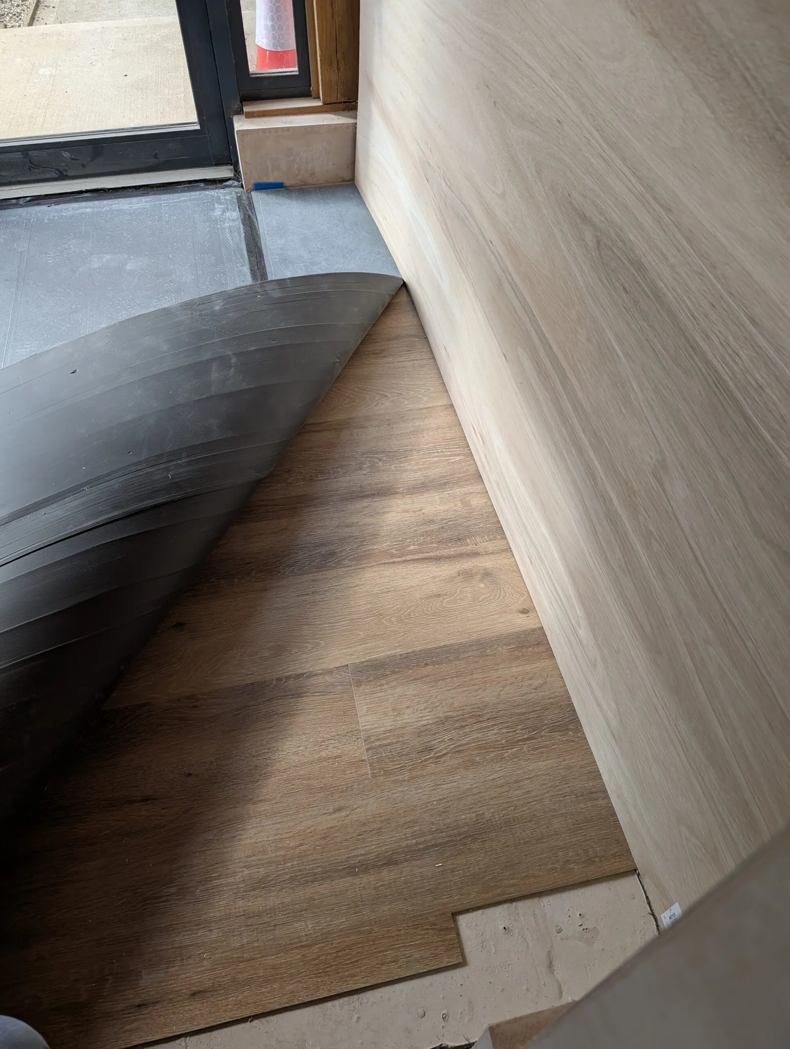 The new corridor's flooring being laid at the side entrance