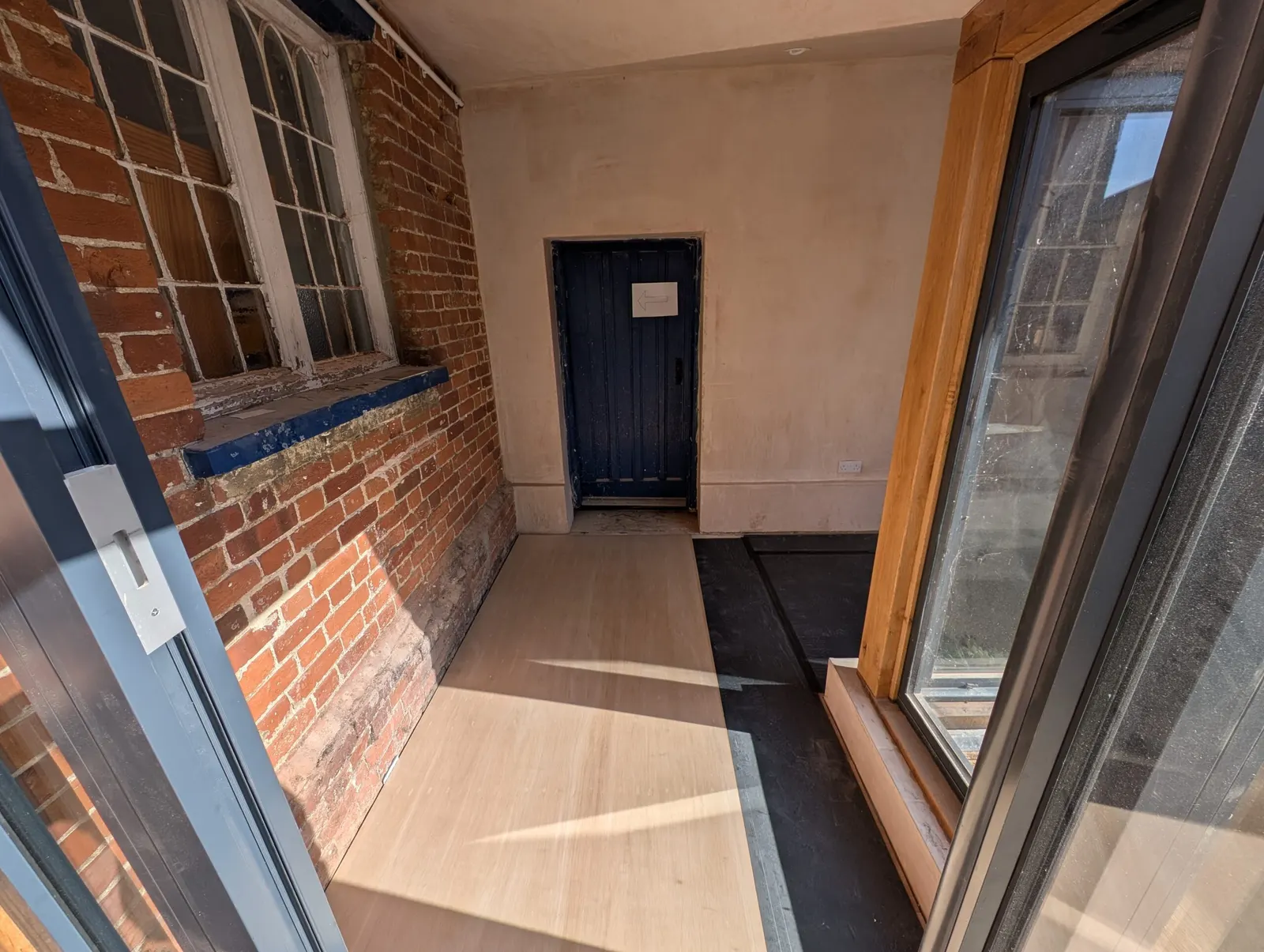 The brick corridor with wayfinding signage by the new side door