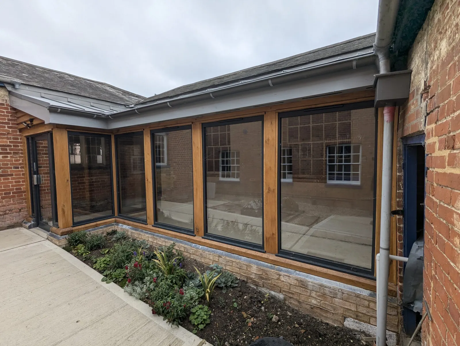 The new corridor taking shape, with its arched windows and glazed wall